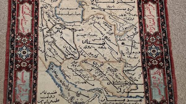 Iran’s image on a carpet woven by Iranian schoolgirls 100 years ago